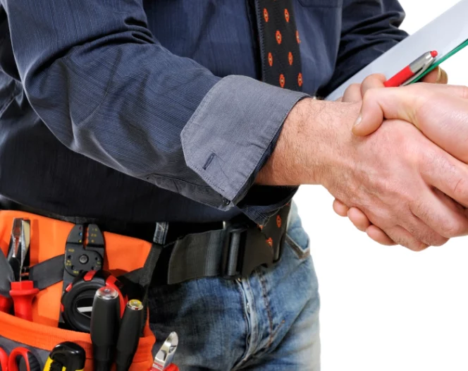 electrician with tool belt shaking hands